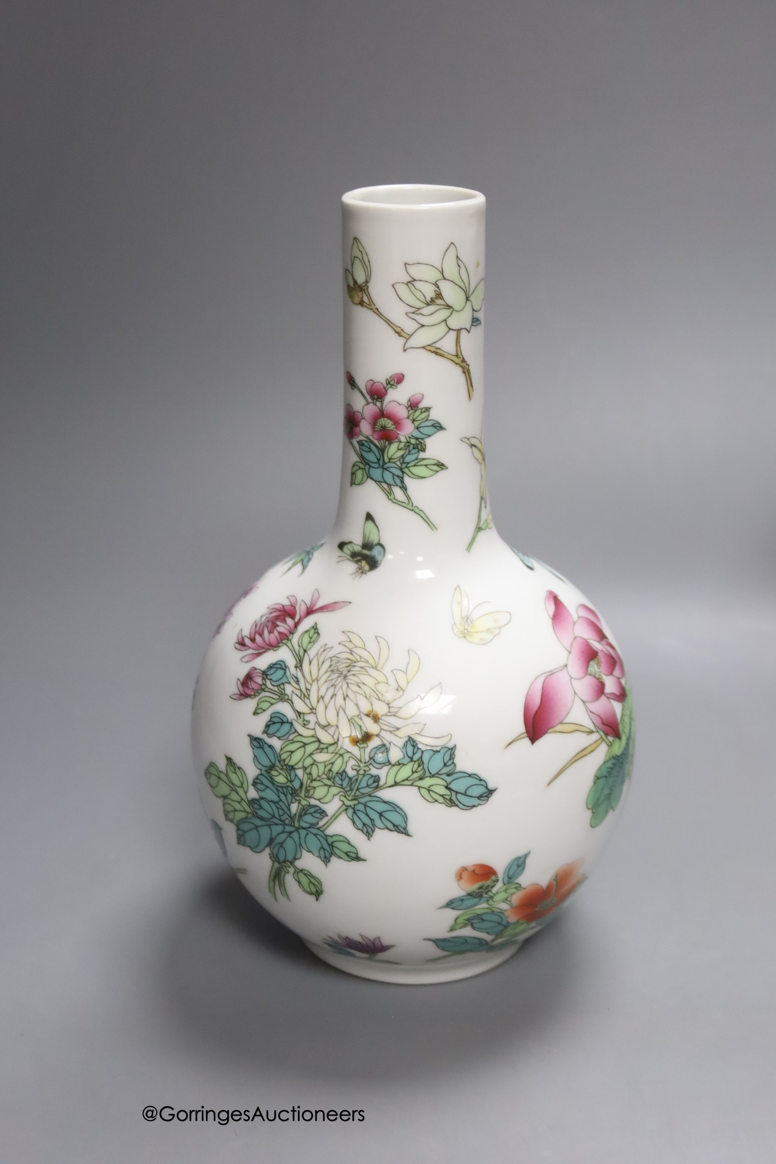 A Chinese famille rose bottle vase and a similar jar and cover and two celadon glazed vases, tallest 24cm